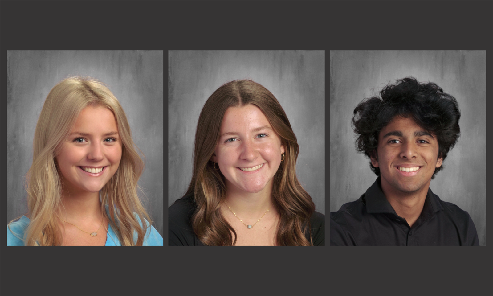 Three students smile